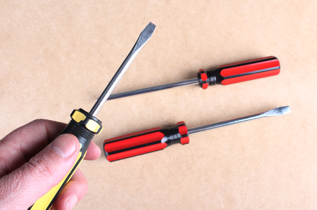 Hand with a yellow screwdriverのeditorial素材