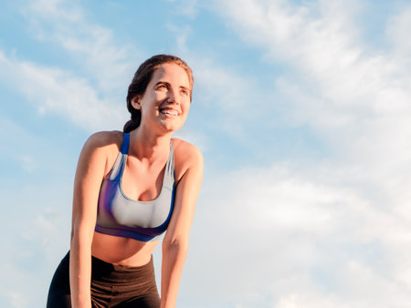 Young woman in sportswear taking a break from runningの写真素材