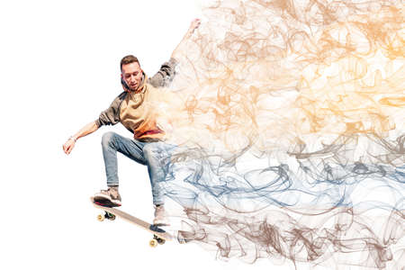 Young man jumping a skateboard leaving a trail of colored smoke on a white background.の写真素材