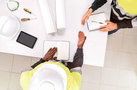 Top view of two people shaking hands during a meeting.の写真素材