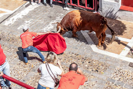 Arcos de la Frontera, SPAIN-April 17, 2022: Man bullfighting in the streets of Arcos de la Frontera during Holy Week at the Aleluya festivities.のeditorial素材