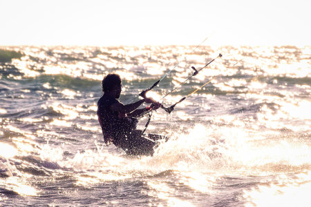 Silhouette of a kitesurf on a sunsetの写真素材