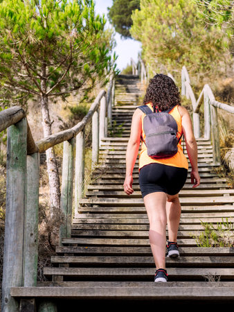 Woman with backpack climbing stairs