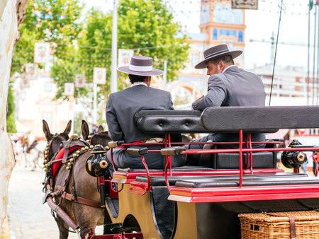 Seville, Spain - May 04, 2022 : Horse drawn carriages at the April Fair (Feria de Abril), Seville Fair (Feria de Sevilla), Andalusia, Spainのeditorial素材