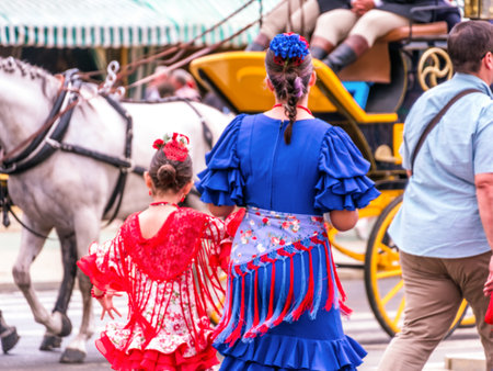 SEVILLE, SPAIN - May 04, 2022 - People taking a walk and dressed in traditional costumes at the Seville's April Fair.のeditorial素材