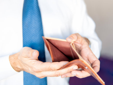 Man's hands holding empty wallet. Savings and investment concept. Select focus.