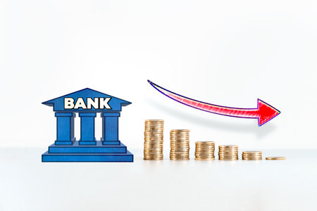 Piles of money coins with a bank icon. Concept of financial crisisの写真素材