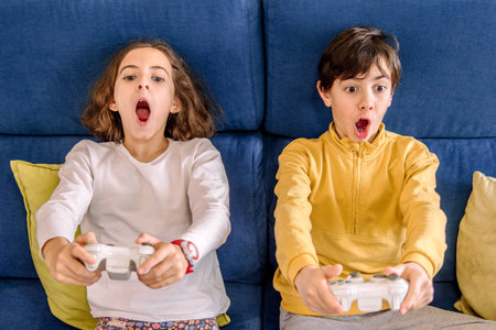 Excited Children Immersed in Console Gaming