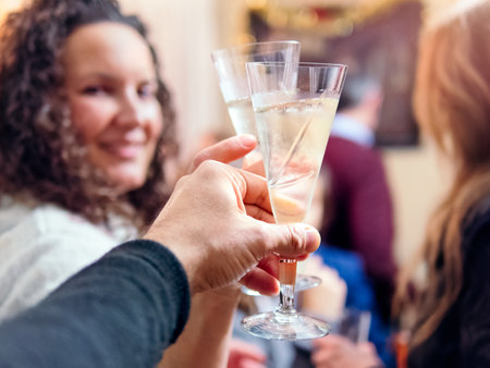 Hand Holding Champagne Flute at Celebrationの写真素材