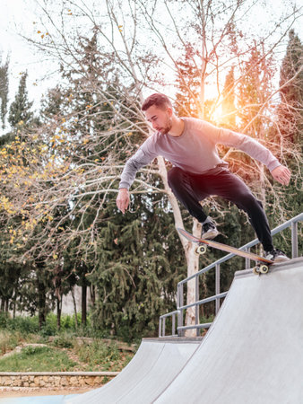 Young Skateboarder Performing Trick at Skatepark.の写真素材