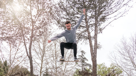 Skateboarder Performing a Jump Trick in a Parkの写真素材