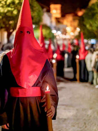 Arcos de la Frontera,CÃ¡diz, Spain - April 17, 2025 : Nazareno holding a lit candle during holy week processionのeditorial素材