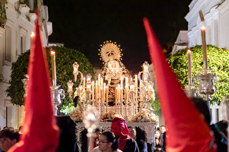 Sacred image of Virgin Mary on a silver float during Holy Week night processionのeditorial素材