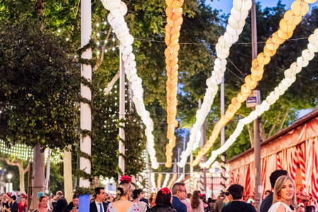 Crowded street decorated with lanterns during the Seville April Fair