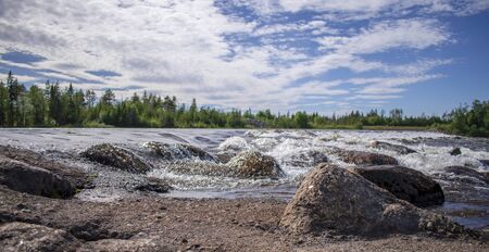 River and stones in a warm summer day.の写真素材