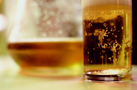A glass and a pitcher of beerの写真素材