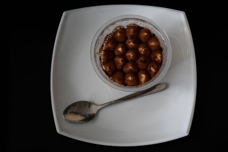 cold tiramisu dessert served on plate with spoonの写真素材