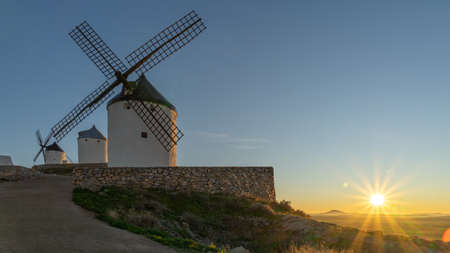 sunset next to old windmills in Europeの写真素材