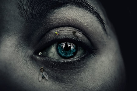 Women dark eye scene with flies in the face.