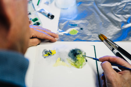 Man painting with airbrushing a work of artの写真素材