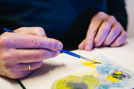 Man painting with airbrushing a work of artの写真素材