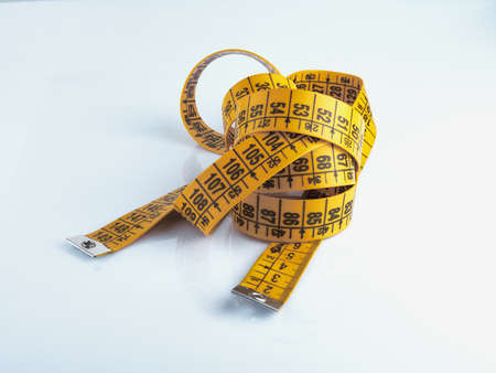 Yellow measuring tape isolated on white background.の写真素材
