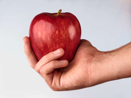 human hand with red appleの写真素材