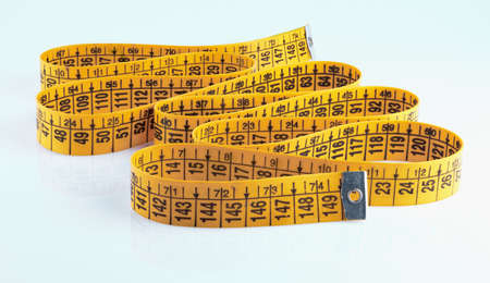Yellow measuring tape isolated on white background.の写真素材