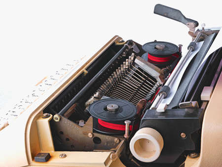 vintage typewriter with blank paper isolated on white backgroundの写真素材
