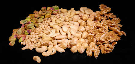 Nuts mix of pistachios, pine nuts, cashew nuts, on dark backgroundの写真素材