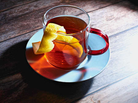 tea with lemon on wooden table and blue dishの写真素材
