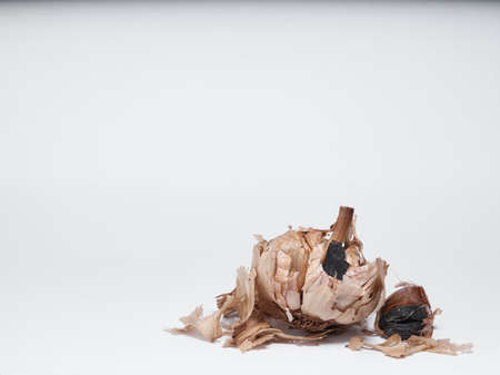 Black garlic cloves isolated on white backgroundの写真素材