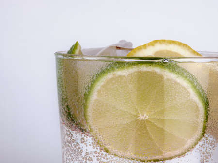 Seltzer water with lime and lemon wedgeの写真素材