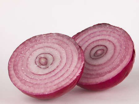 Sliced red onion rings isolated on white backgroundの写真素材