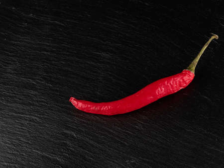 Red chili pepper hot and spicy dark background