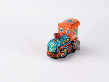 Old design train toy. Isolated metal colors train toy profile view.の写真素材
