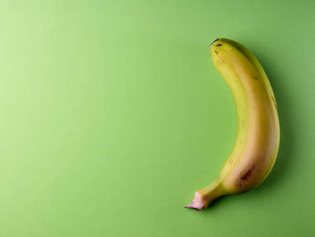 Yellow banana on green backgroundの写真素材