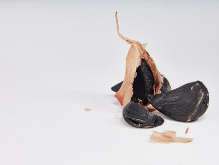 Black garlic isolated on a white backgroundの写真素材