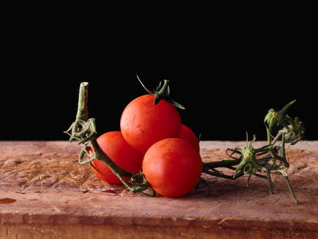 Ripe Tomatoes on wood table dark backgroundの写真素材