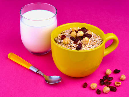 Glass milk, oatmeal bowl and nuts with spoonの写真素材