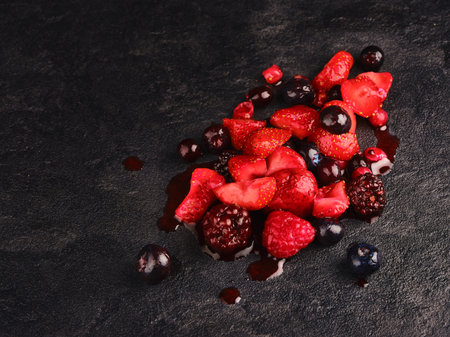 Red berries. Red fruits on dark backgroundの写真素材