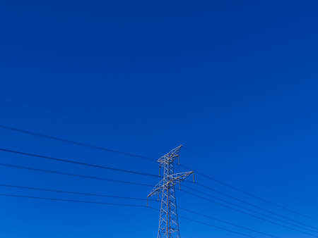 high voltage electric tower on clean blue skyの写真素材