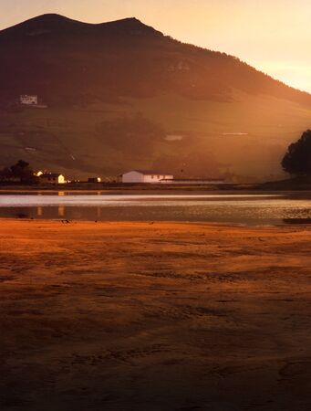 Red Arenal at sunset with light raysの写真素材