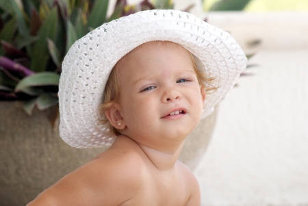 Baby girl with a hatの写真素材