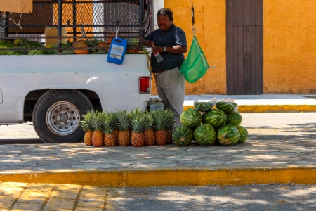 Merida,Yucatan, Mexico - March 30, 2013: A Man Selling Watermelon and Papaya on the streets of a Yucatan small town or "pueblo"のeditorial素材