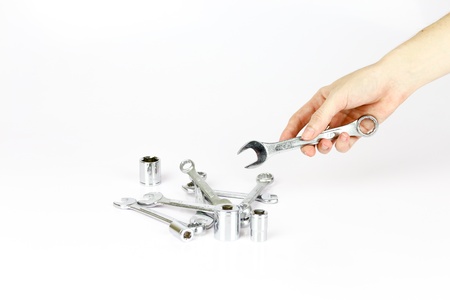 Hand holding a bunch of working toolsの写真素材
