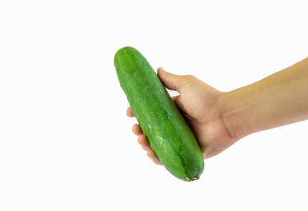 Man hand showing a fresh cucumberの写真素材