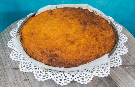 homemade pumpkin pie on a blue background and a wooden table