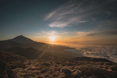 sunset where you can see a mountain and warm and cold colorsの写真素材