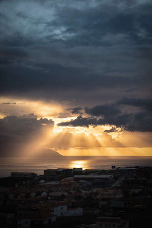 sunset where you see the clouds and the sun's rays through the cloudsの写真素材